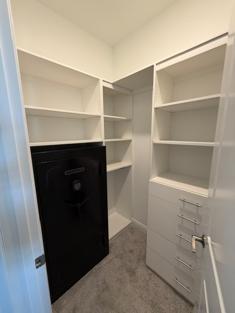Custom walk-in closet with built-in cabinetry and drawers