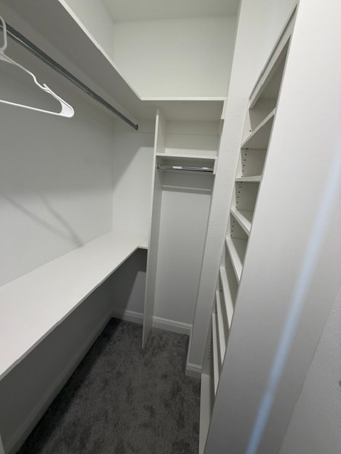 Walk-in closet with center tower and shelving