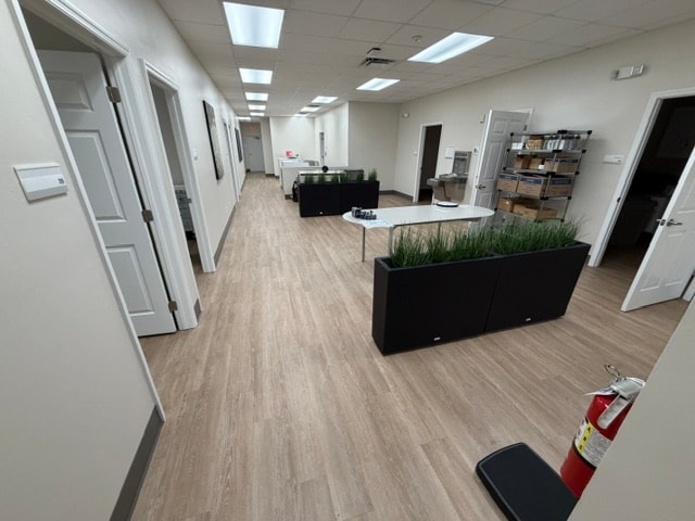 Commercial waiting room with 3D wave wallpaper and LVP flooring