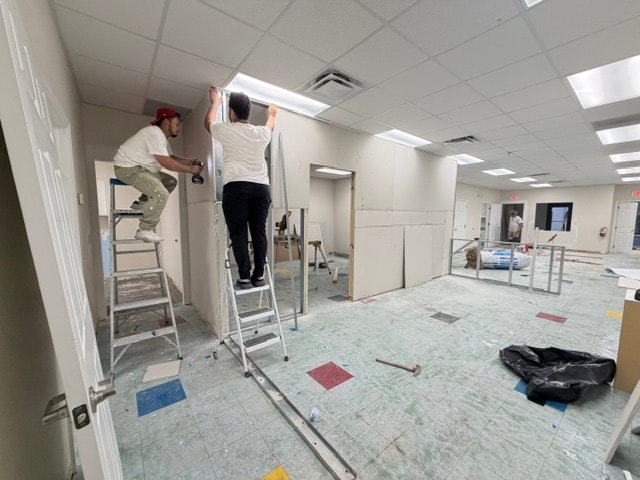 Commercial ADA-compliant restroom with LVP flooring and accessories