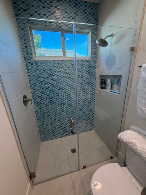 Bathroom shower renovation with blue fish scale tile