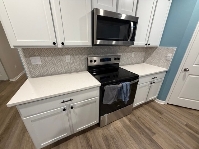 Kitchen remodel with white cabinets and herringbone backsplash